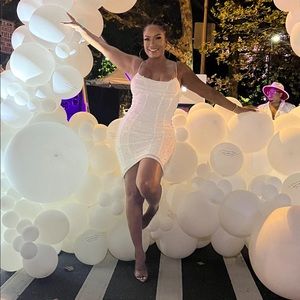 This white beaded dress is super sexy and will turn heads.